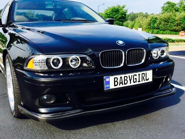 A black BMW with a license plate that says babygirl