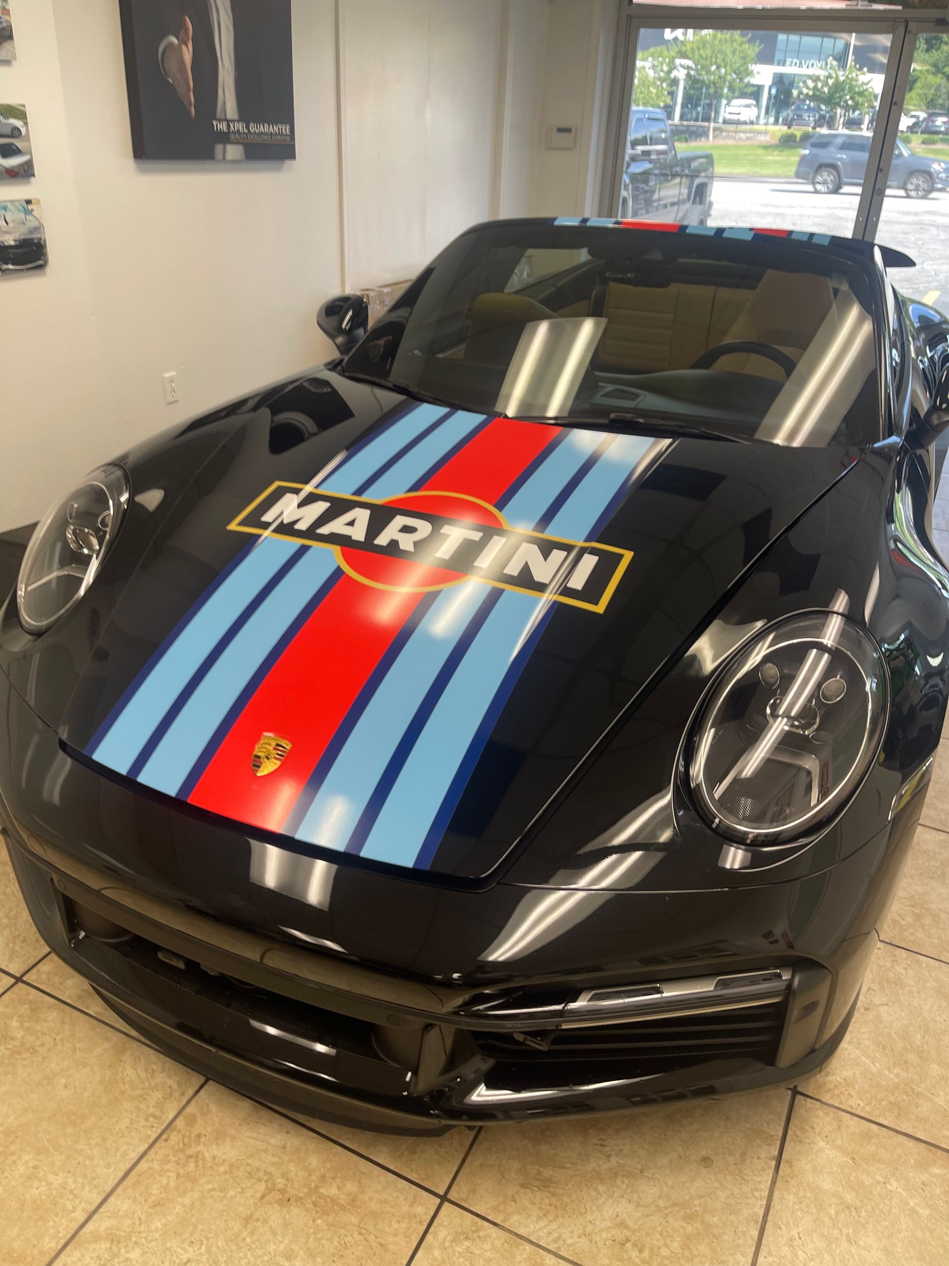 A black Martini car is parked in a garage