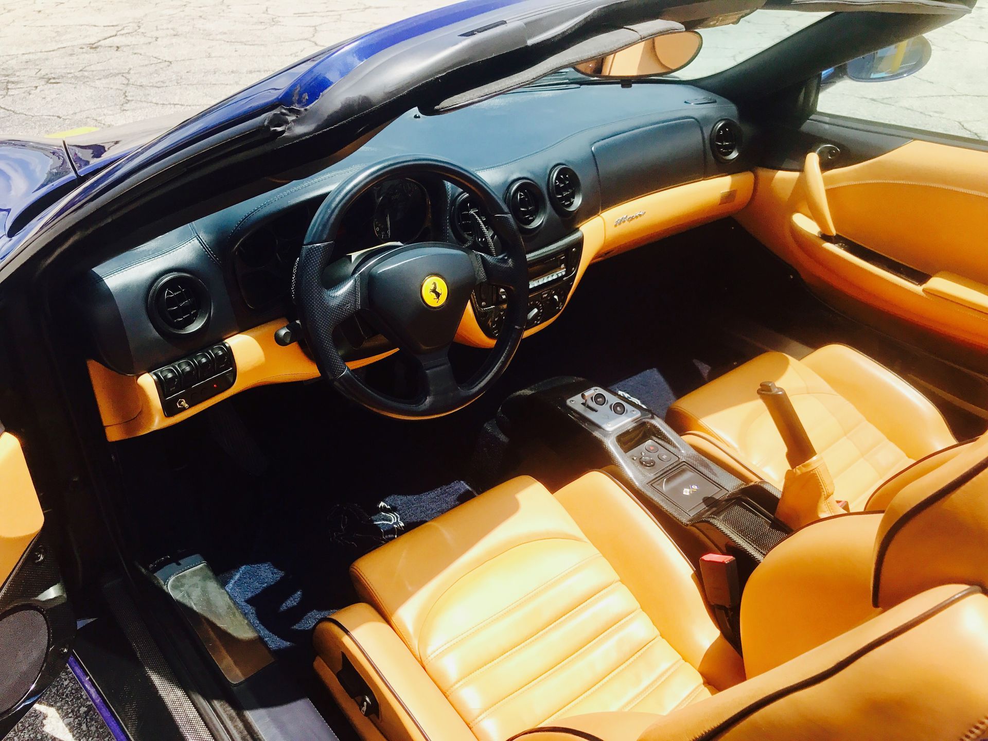 The interior of a Ferrari convertible with the top down