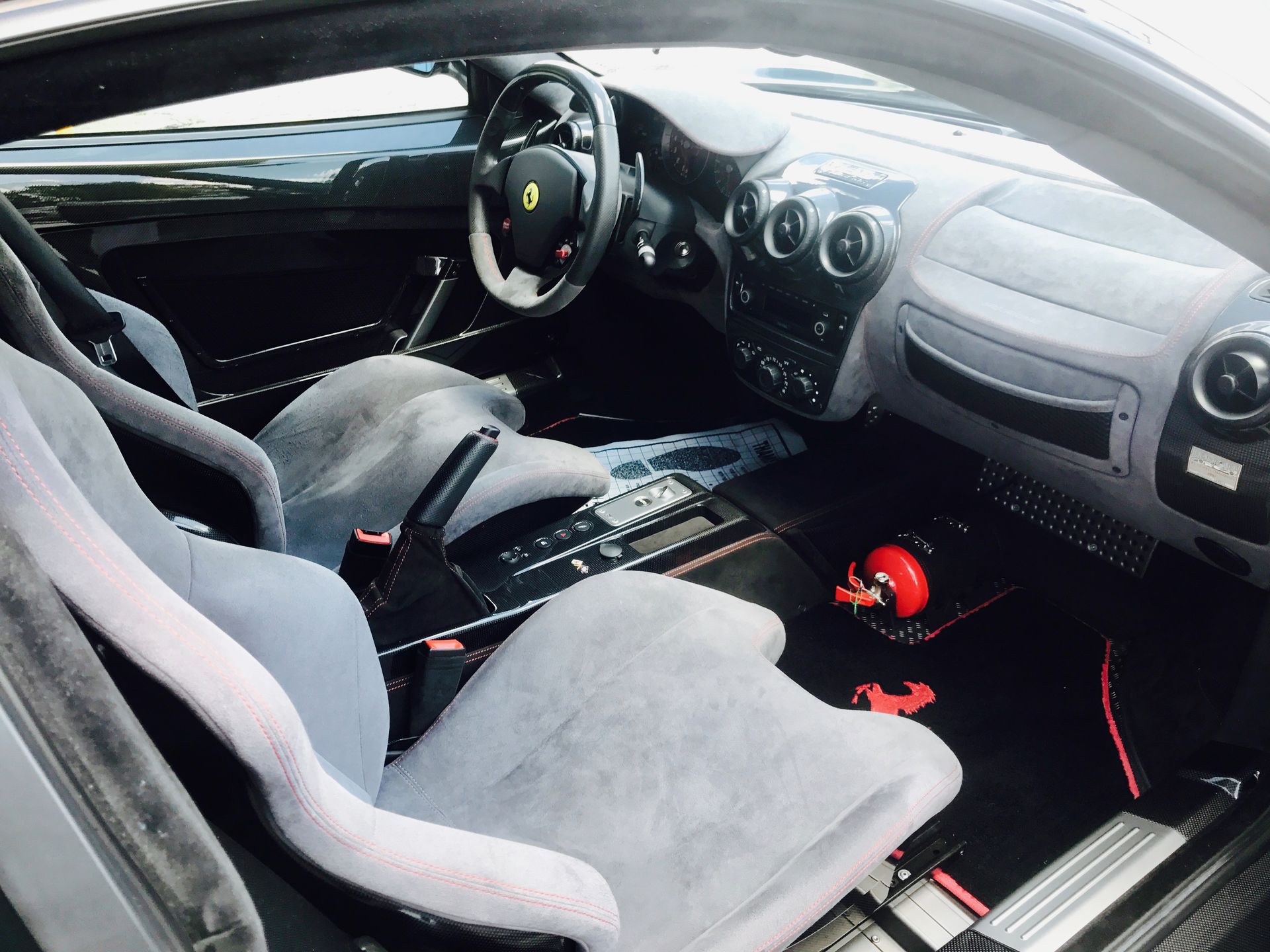 The inside of a car with a steering wheel and seats