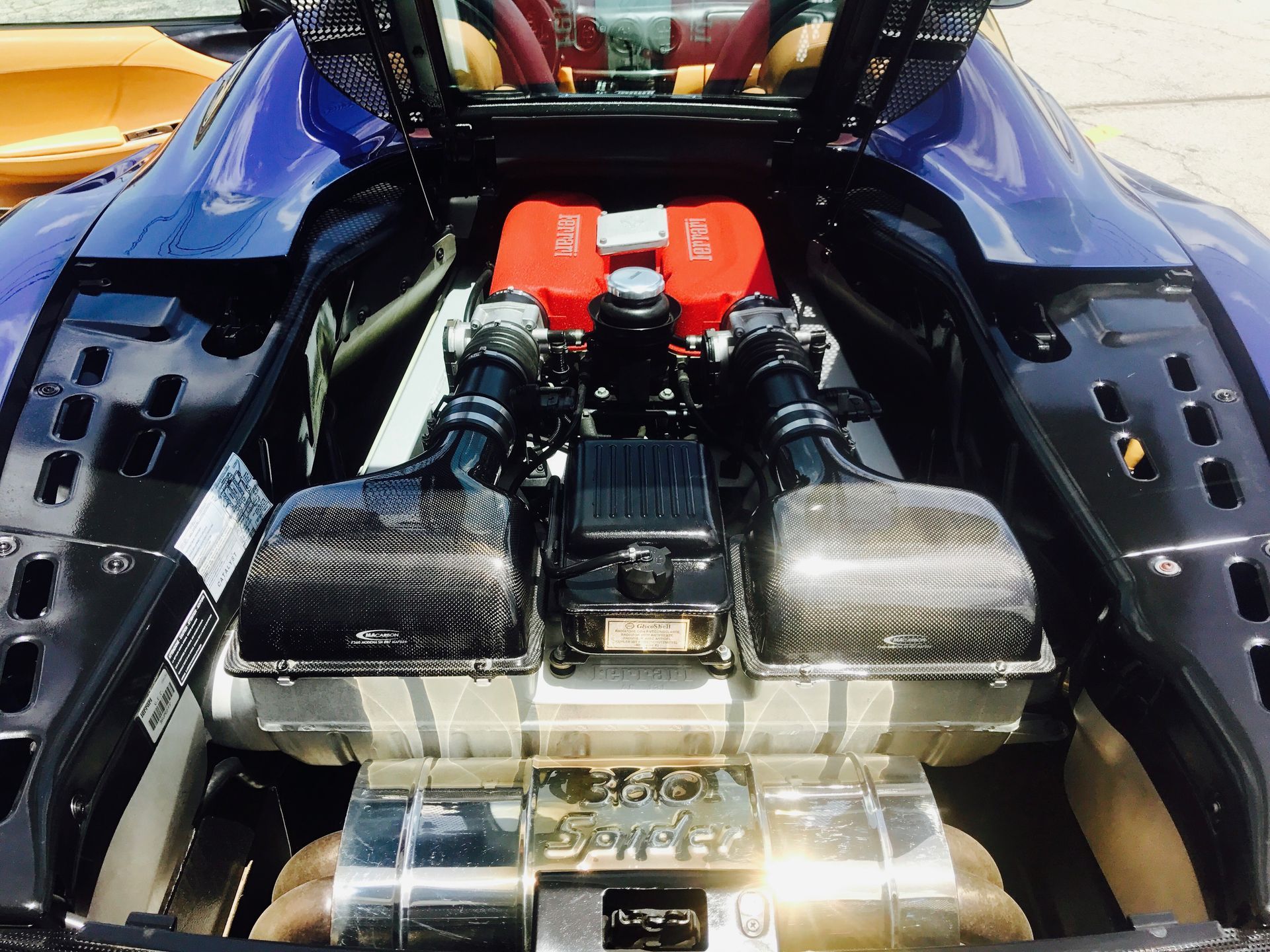 A Ferrari engine is shown with the hood open