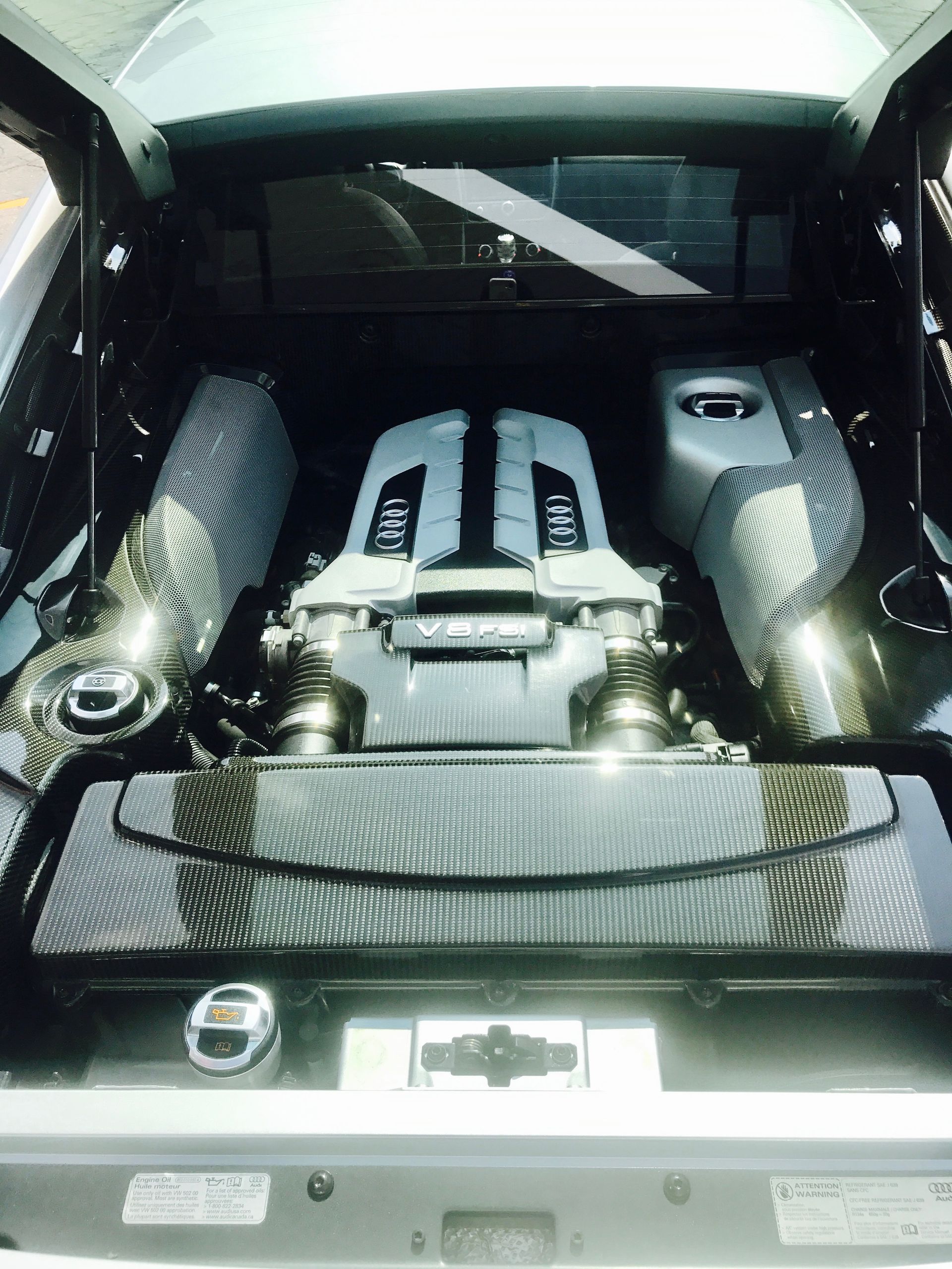 A car with the hood open and the engine visible