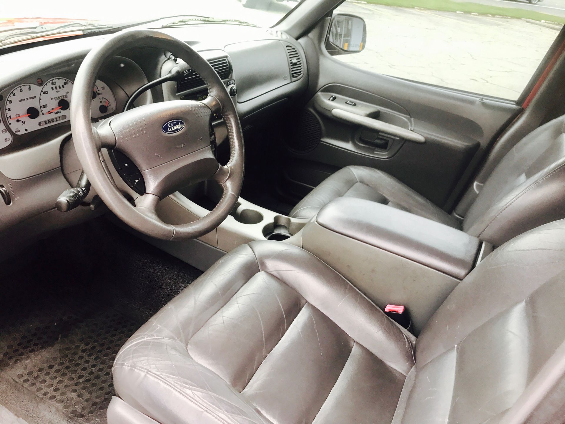The interior of a ford truck with leather seats and a steering wheel