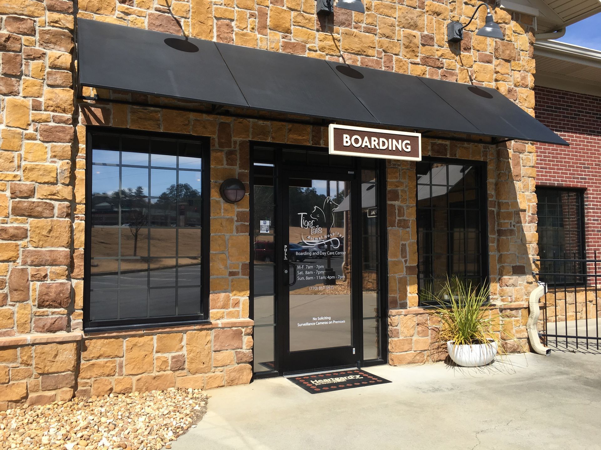 A brick building with a sign that says boarding on it