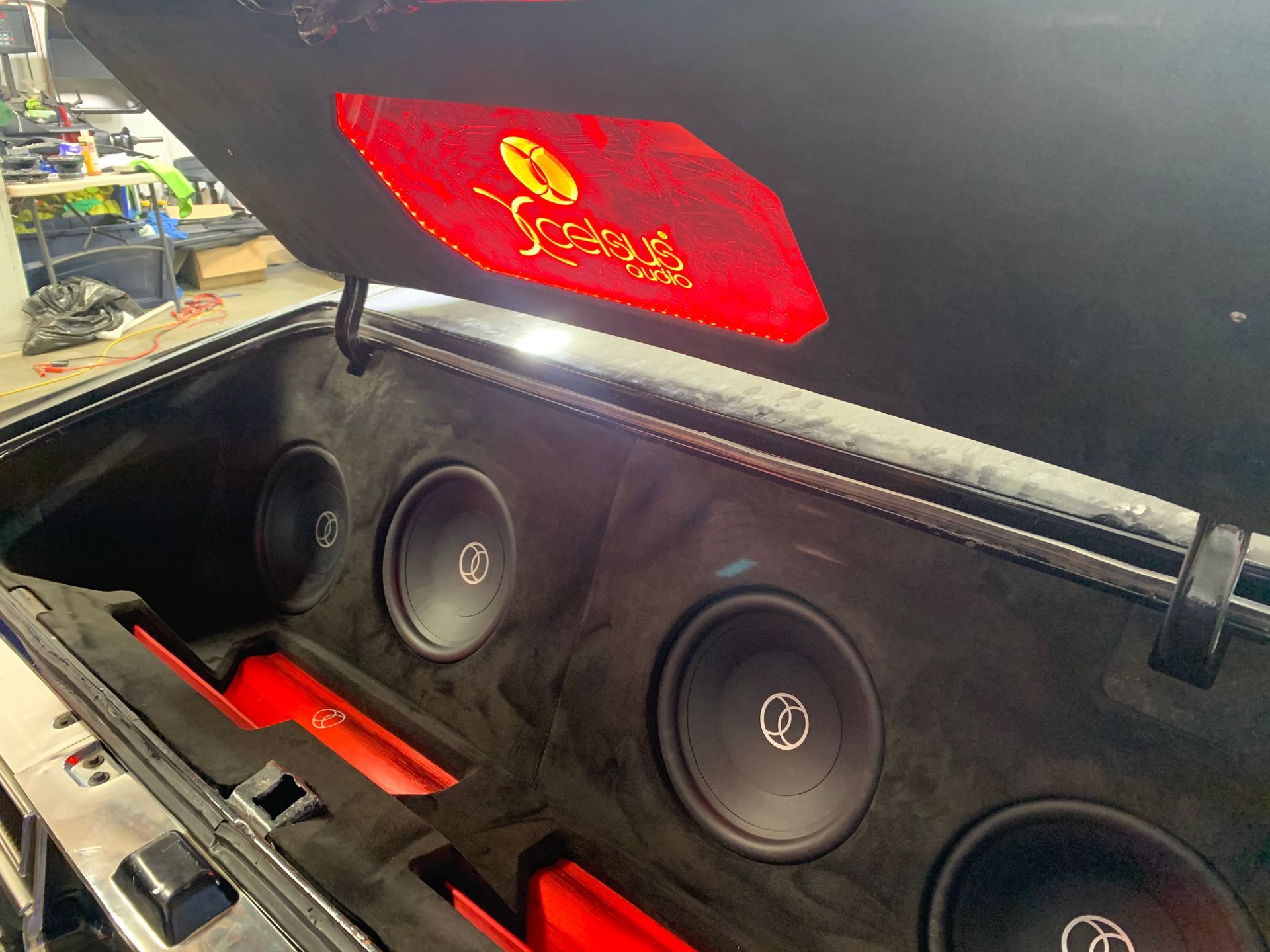 The trunk of a car with a subwoofer and speakers in it