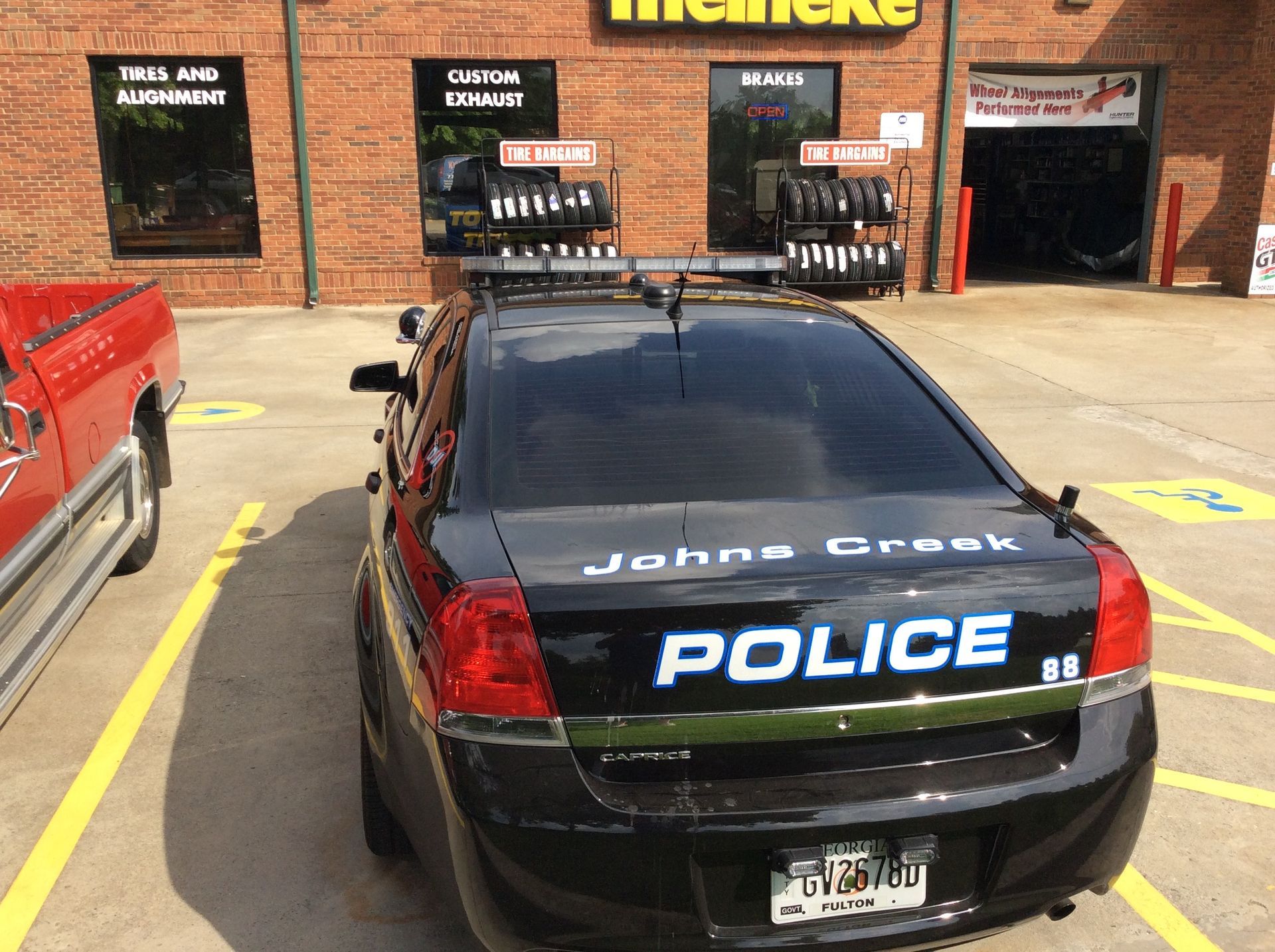 Black police car is parked in a parking lot