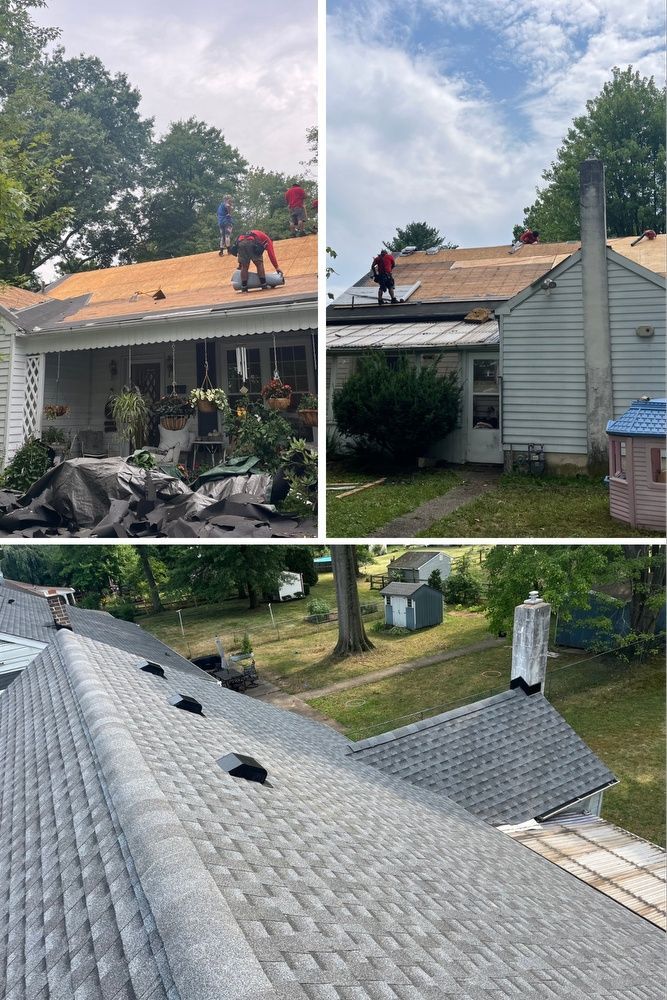 Workers repairing a gray shingle roof on a white house, with old shingles piled in the yard.
