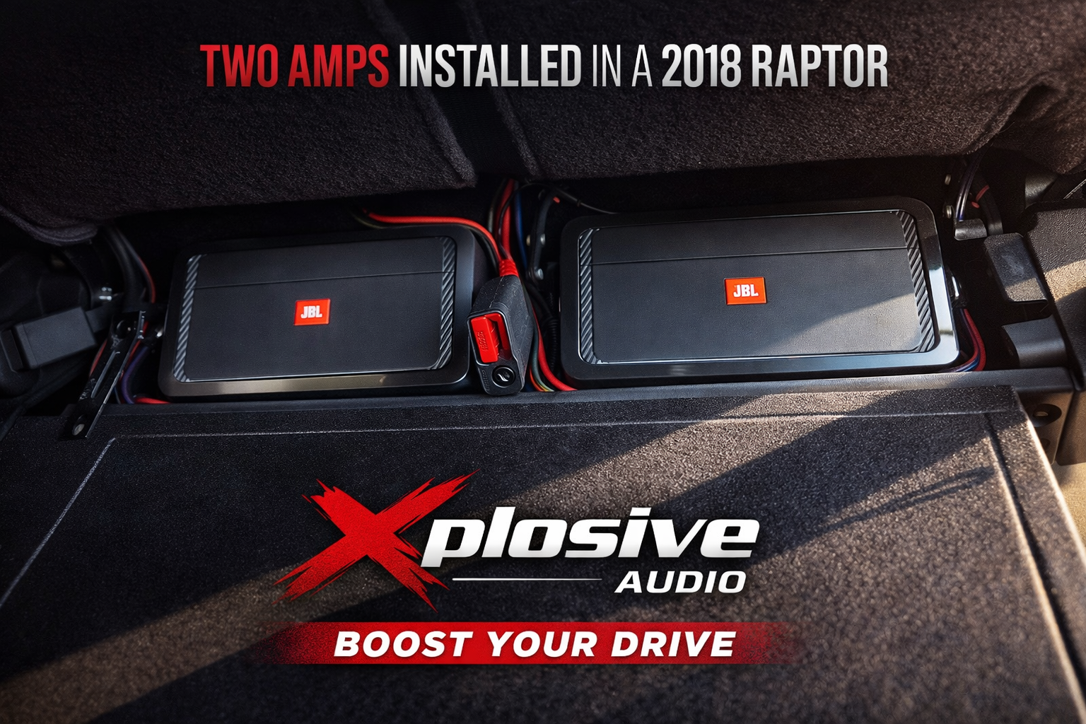 Two JBL amps installed in a 2018 Raptor. The amps are black with orange accents, installed in the truck's cargo area.