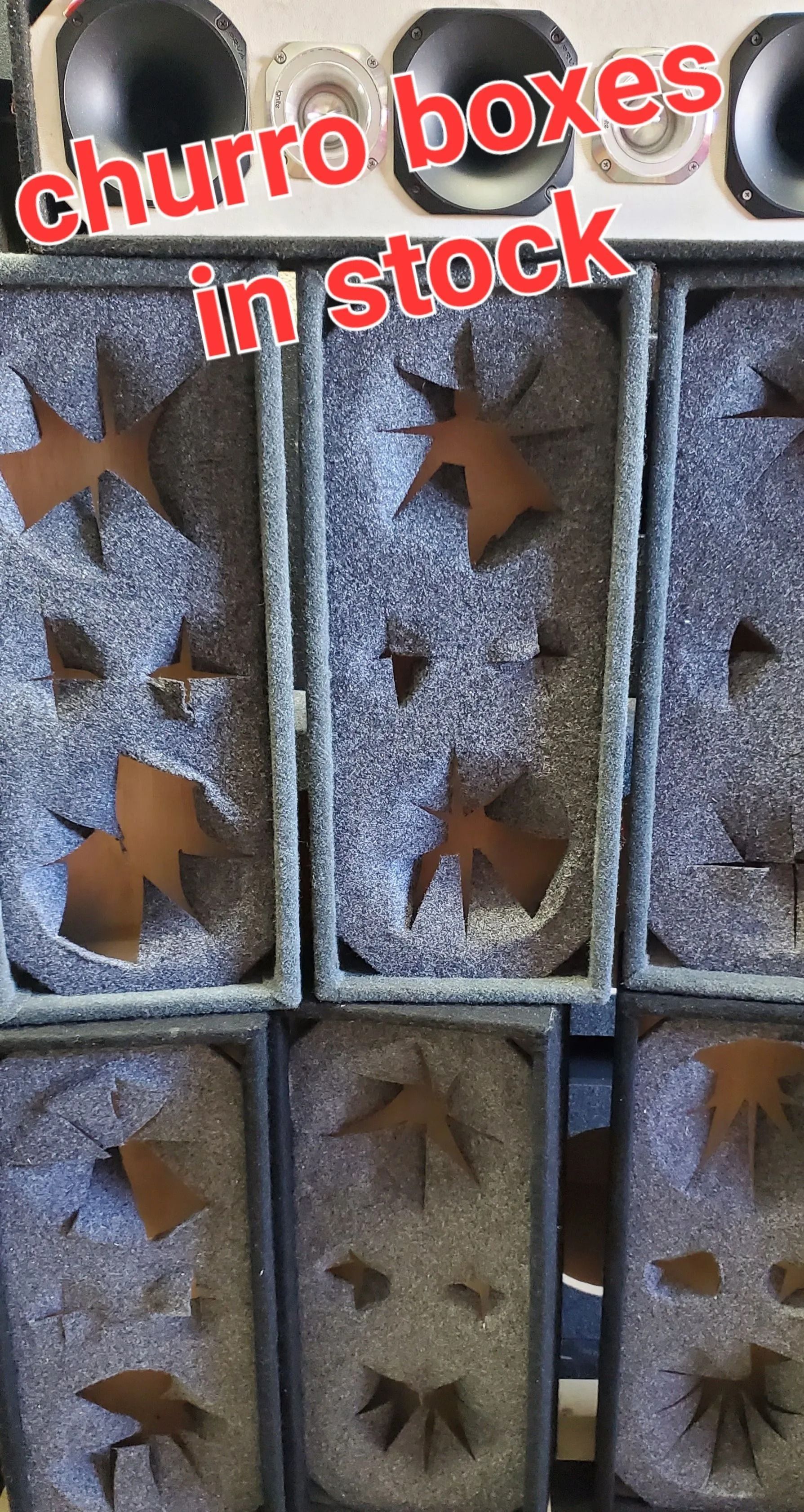 Nine rectangular boxes with gray foam, holding what appear to be bronze star-shaped cutouts. Text reads 