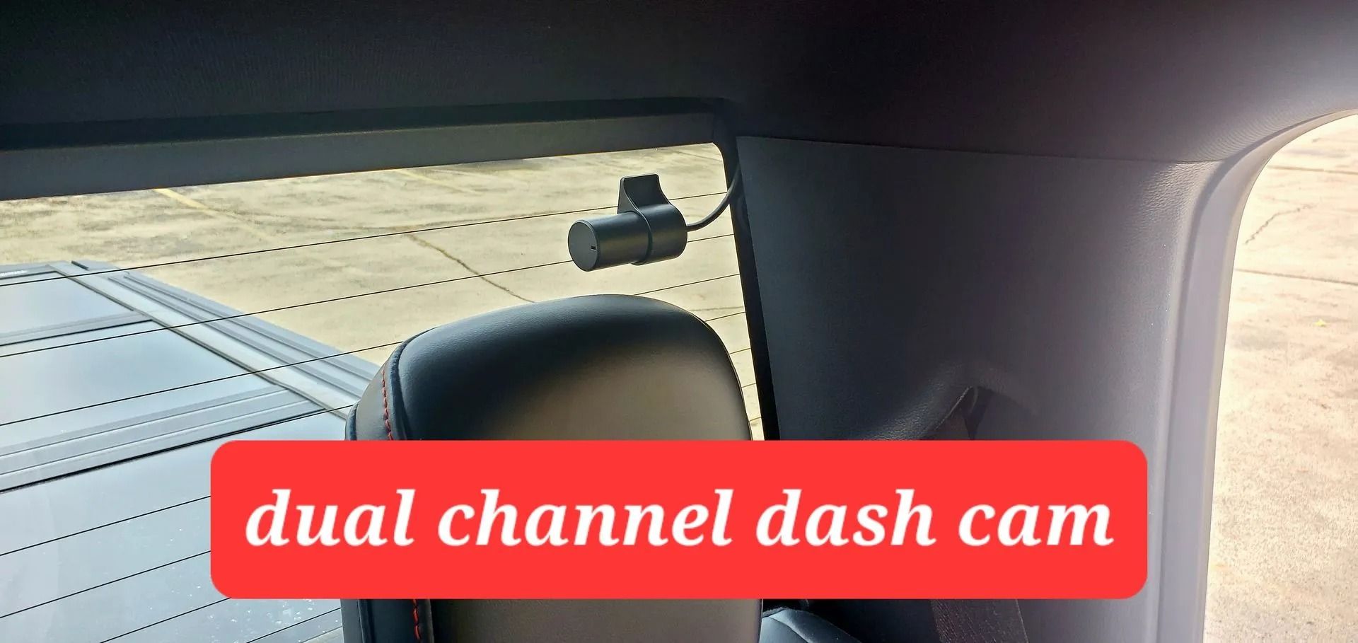 A dual-channel dash cam mounted on the rear window of a vehicle.
