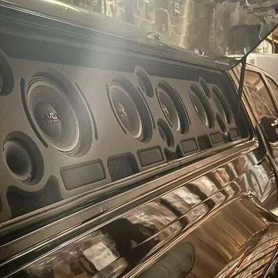 Custom car audio system with multiple speakers in a black vehicle's interior.