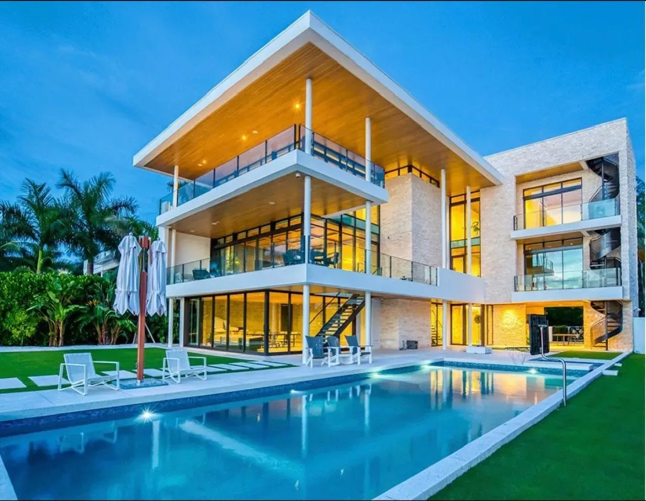 A large house with a swimming pool in front of it
