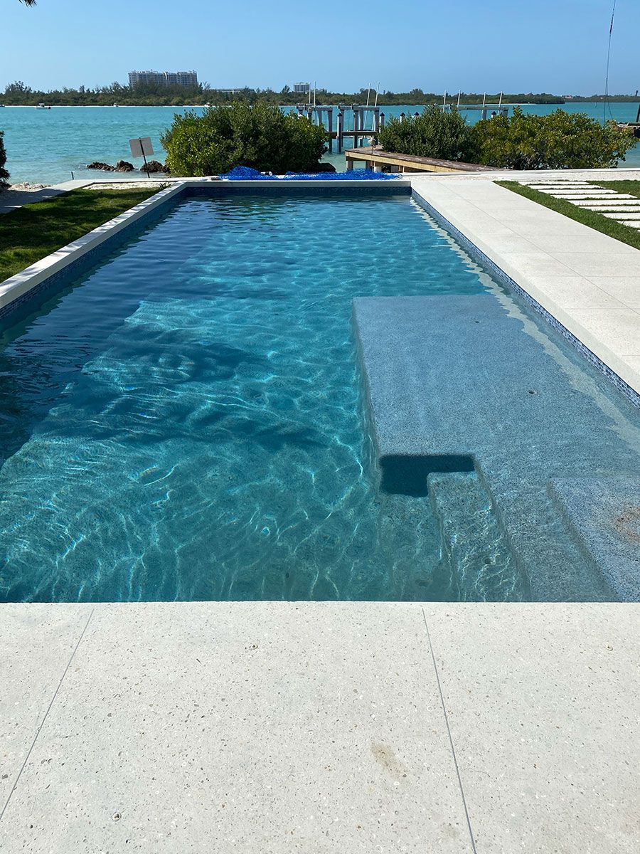 A large swimming pool with steps leading to the water
