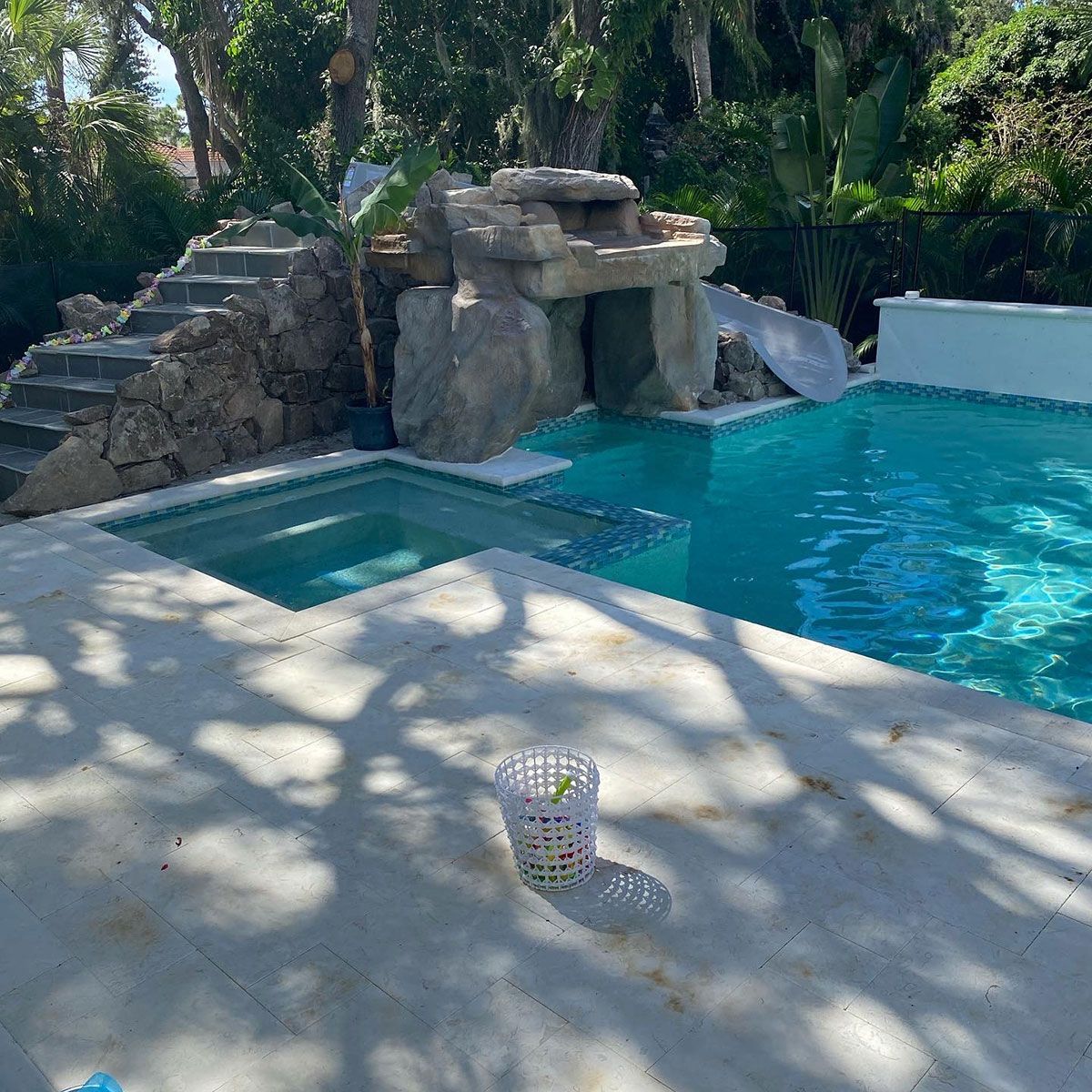 A large swimming pool with a waterfall in the background