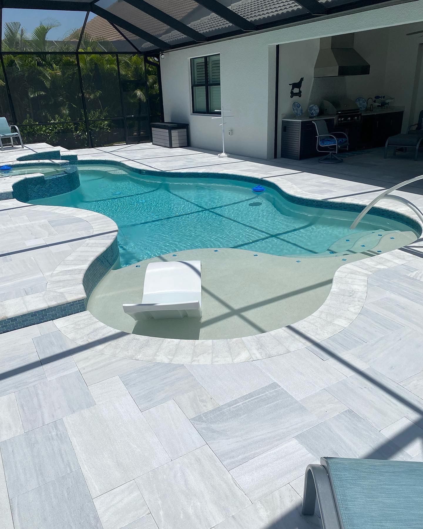 There is a large swimming pool in the middle of a house.