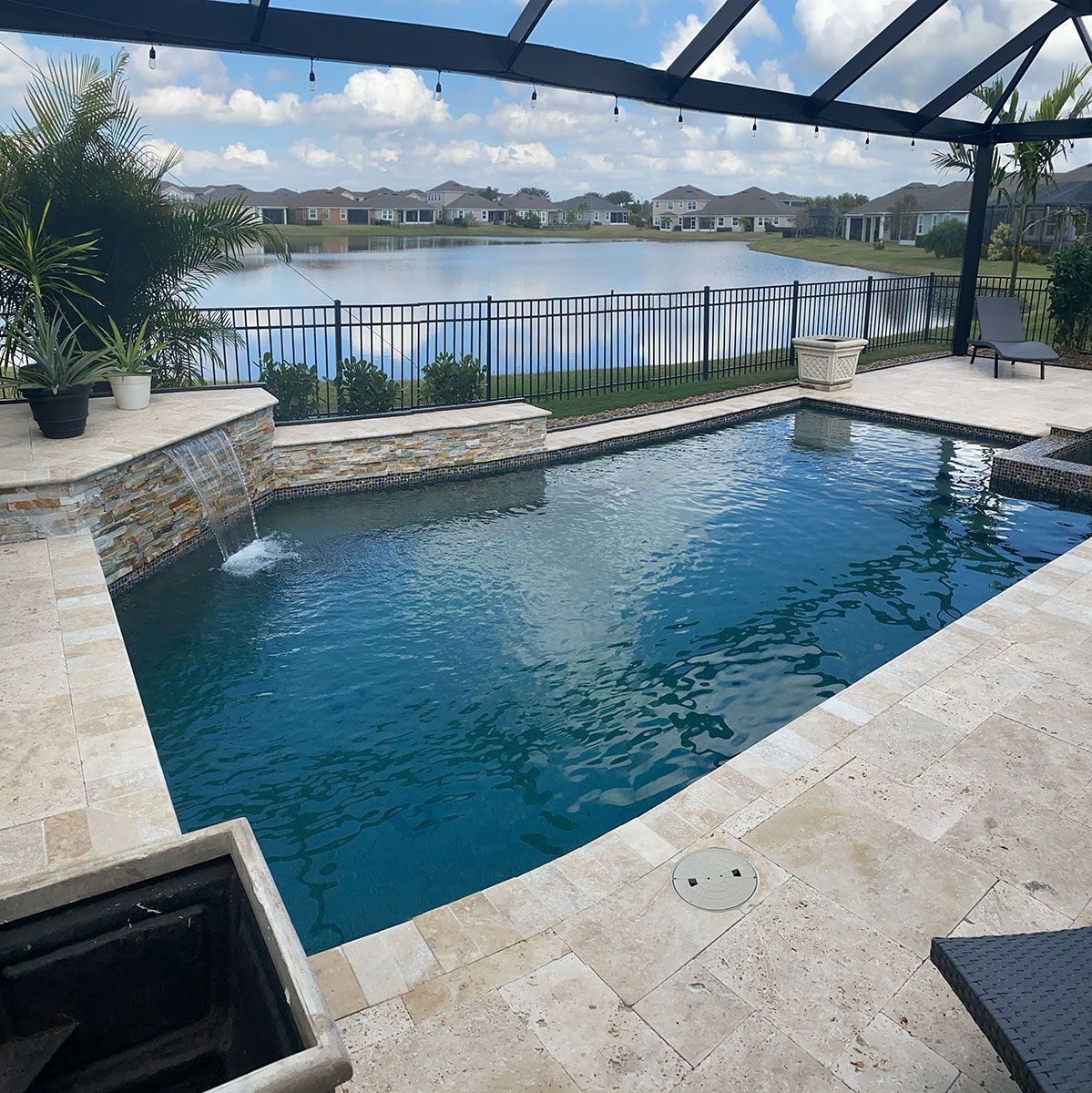 A large swimming pool with a view of a lake