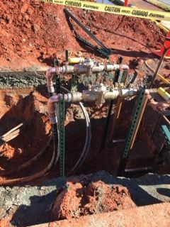 a bunch of pipes are coming out of a hole in the ground