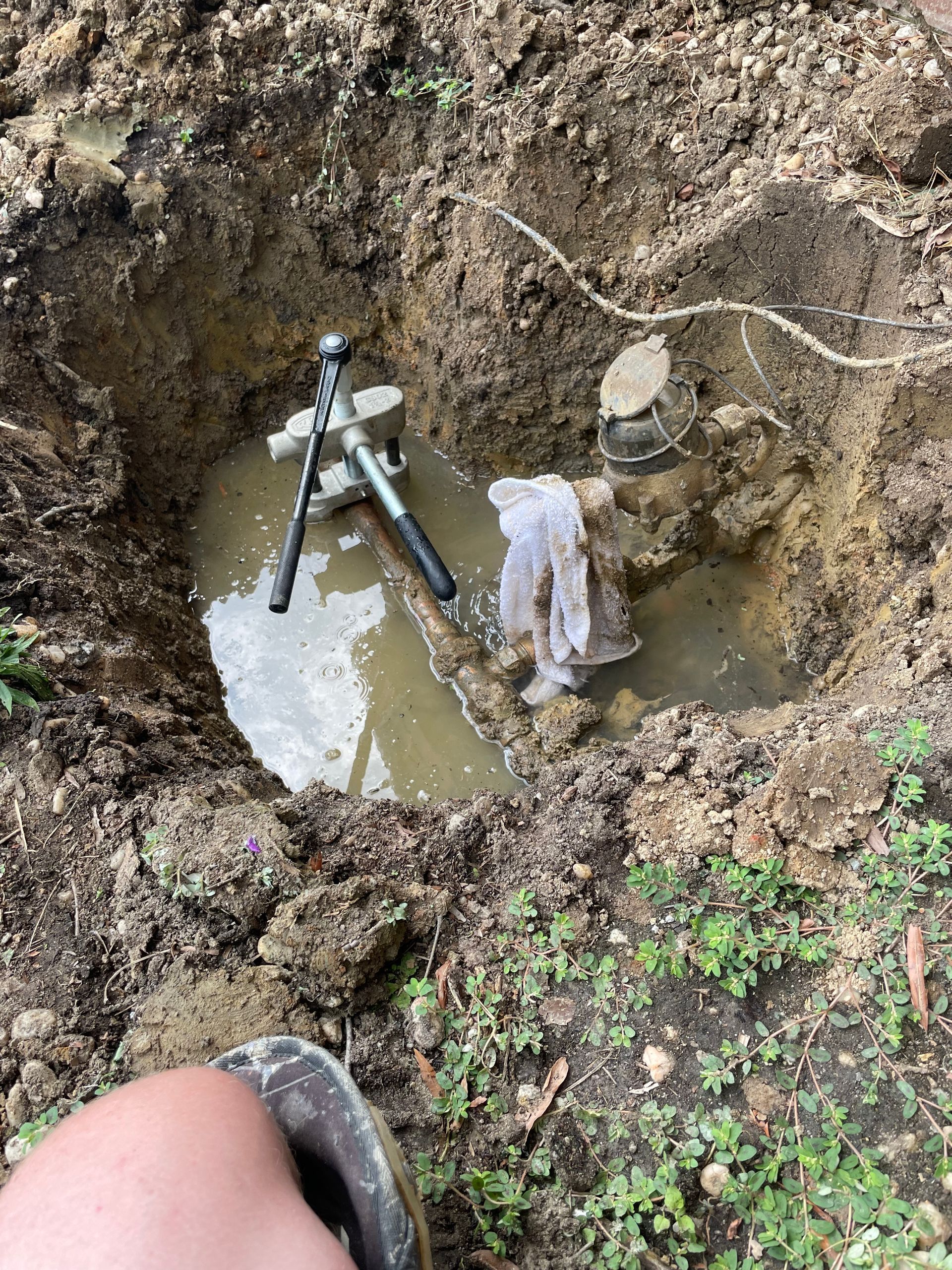 a person is digging a hole in the ground.