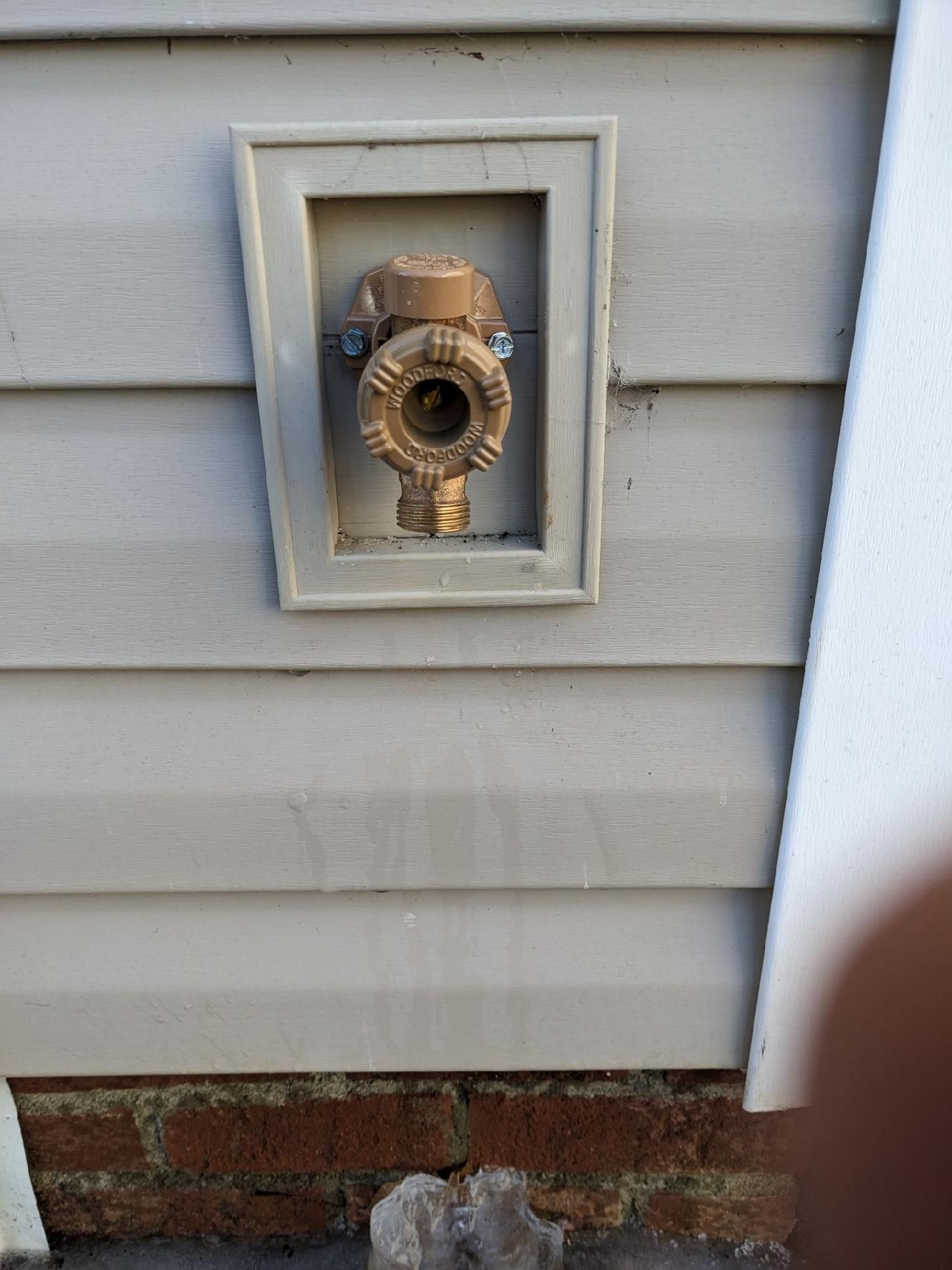 a close up of a faucet on the side of a house .