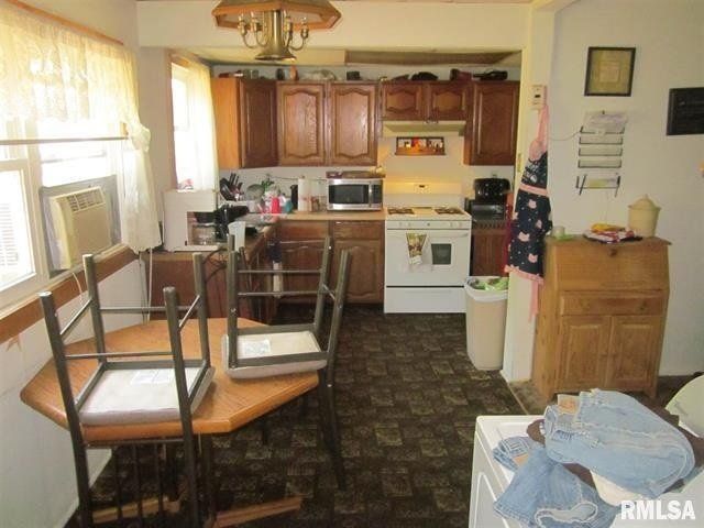 A kitchen with a table and chairs and the word rmlsa on the wall