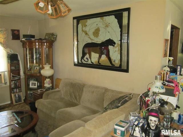 A living room with a picture of a horse on the wall