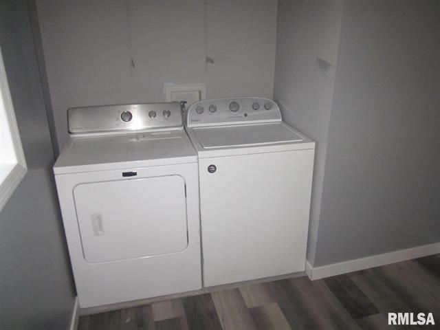 A washer and dryer are sitting next to each other in a laundry room.