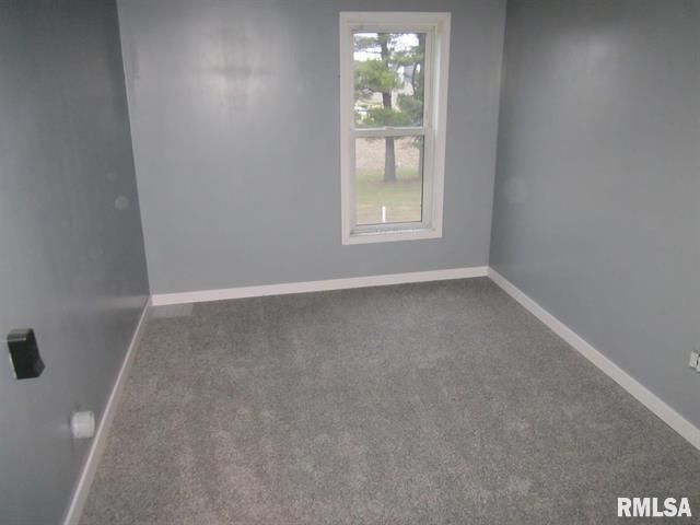 An empty room with a window and the word rmlsa on the bottom