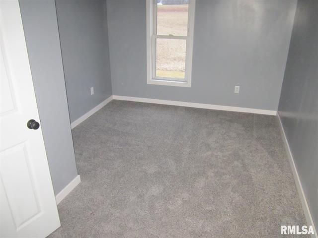 An empty room with a window and a door that says rmlsa on it