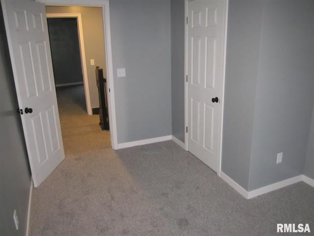 An empty room with a rmlsa logo on the wall