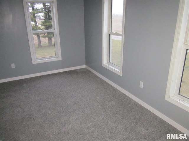 An empty room with a rmlsa logo on the wall