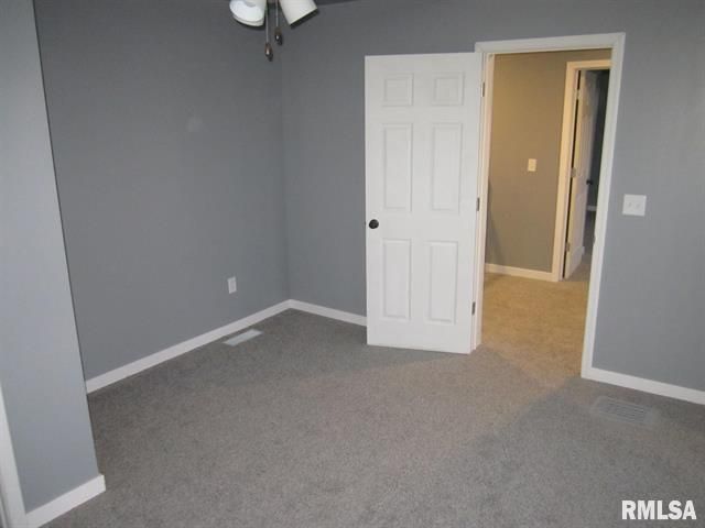 An empty room with a door that says rmlsa on it