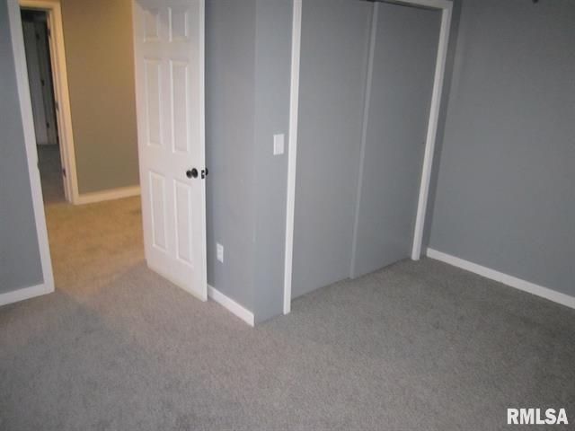An empty room with a door that says rmlsa on it