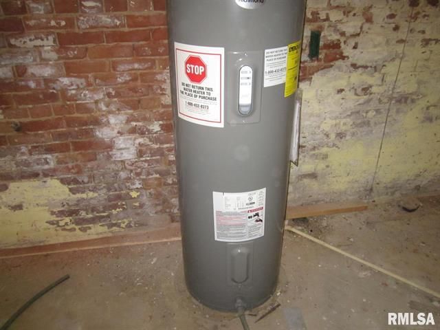A gray water heater with a stop sign on it