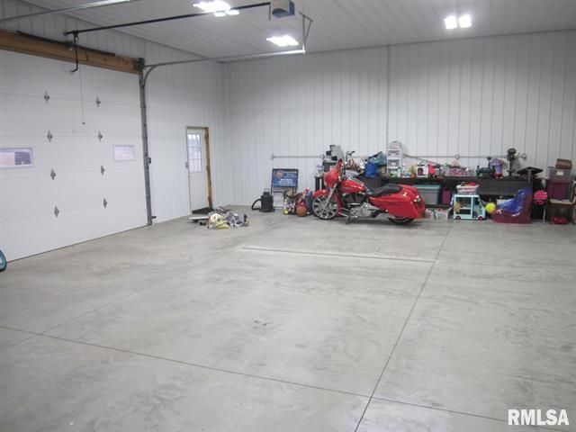 A red motorcycle is parked in a garage.