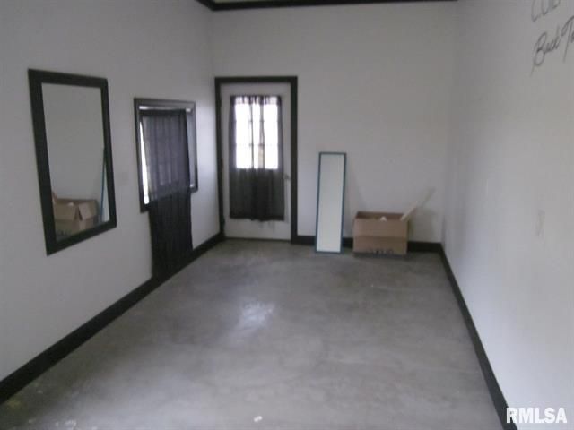 An empty room with a box on the floor and the word rmlsa on the wall