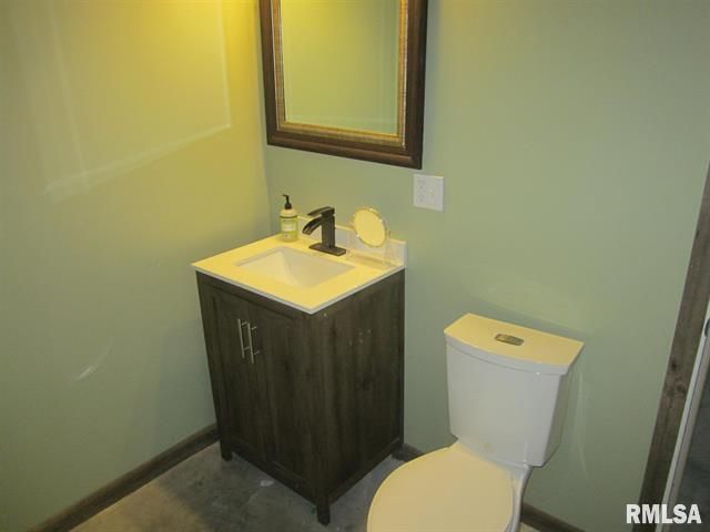 A bathroom with a toilet a sink and a mirror