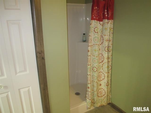 A bathroom with a shower and a door that says rmlsa on it