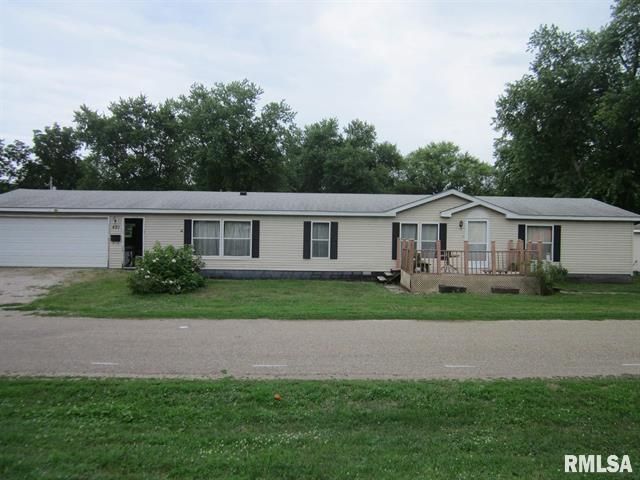 Tan mobile home with attached garage and front porch