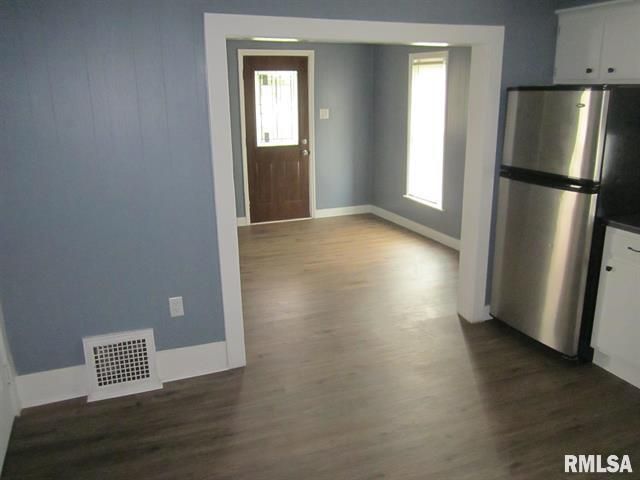 Interior view: blue-walled room with a doorway to another room