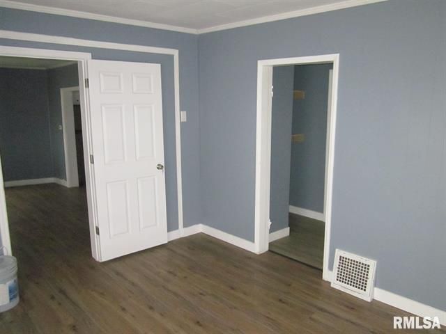 Room with gray walls, white trim, wooden floor