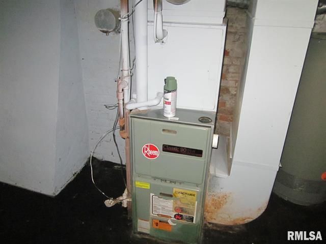 Furnace in a basement, next to a water heater