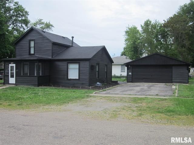 Black house and garage with white trim
