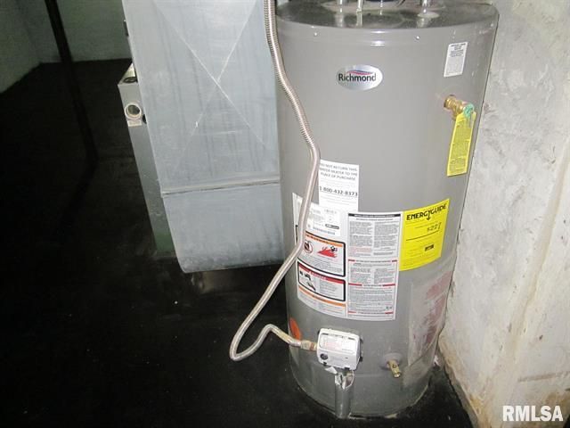Water heater next to a metal air duct in a basement
