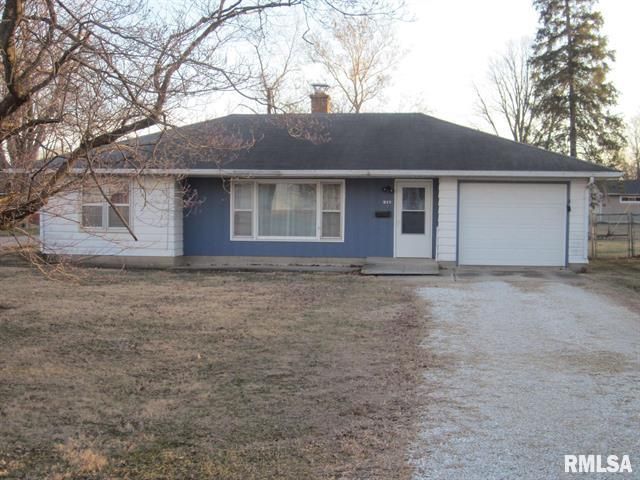 Blue and white ranch-style house with a single-car garage. Brown grass in the front yard. Bare trees in the background.