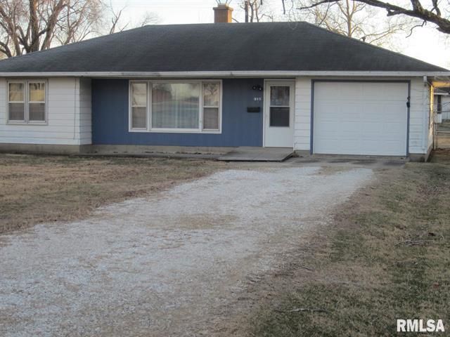Blue and white one-story house with a gravel driveway and attached garage.