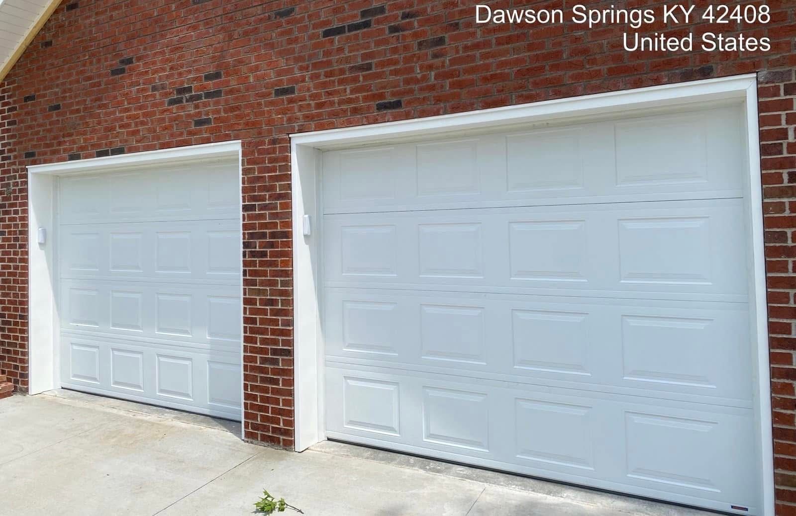 Two white garage doors set in a brick building exterior in Dawson Springs, KY.