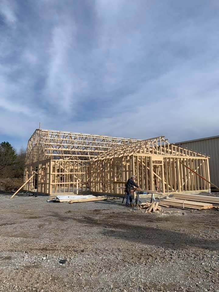 A man is standing in front of a building under construction.