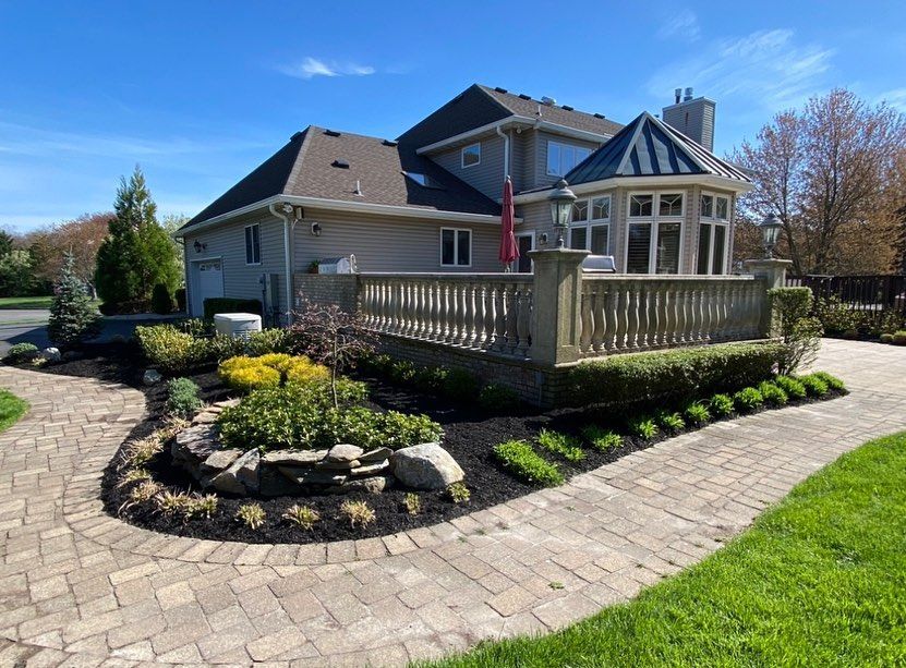 A large house with a brick walkway leading to it