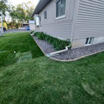 A house with a lush green lawn in front of it.
