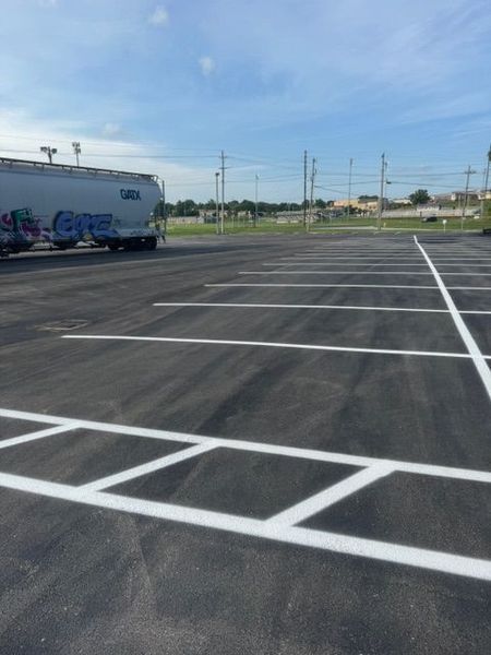 Newly painted parking lot with white lines, and a large tanker truck.